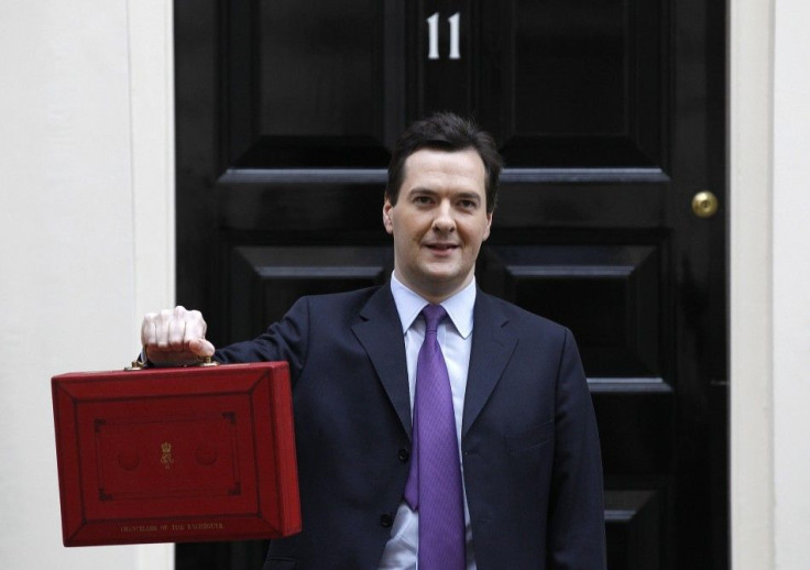 Britain's Chancellor of the Exchequer George Osborne, holds his budget case for the cameras outside number 11 Downing Street, before delivering his budget to the House of Commons in London March 23, 2011. 