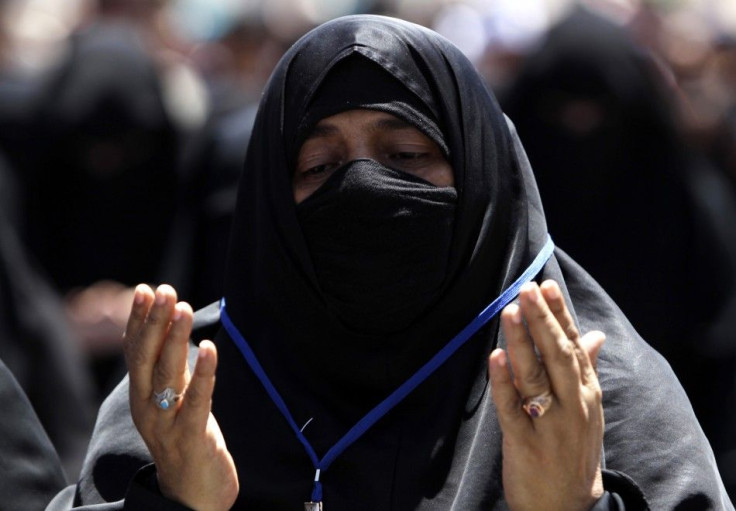 A woman recites prayers during a rally to demand the ouster of Yemen's President Ali Abdullah Saleh outside Sanaa