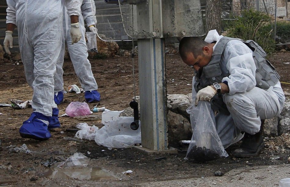 Israeli police explosives experts survey the scene of an explosion in Jerusalem