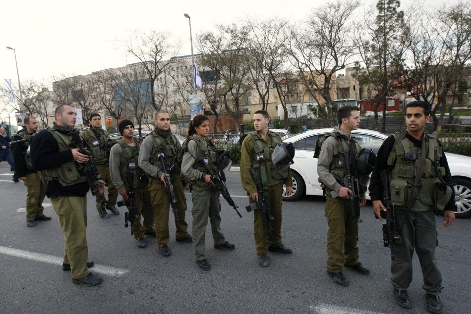 Israeli soldiers stand at the scene of an explosion in Jerusalem