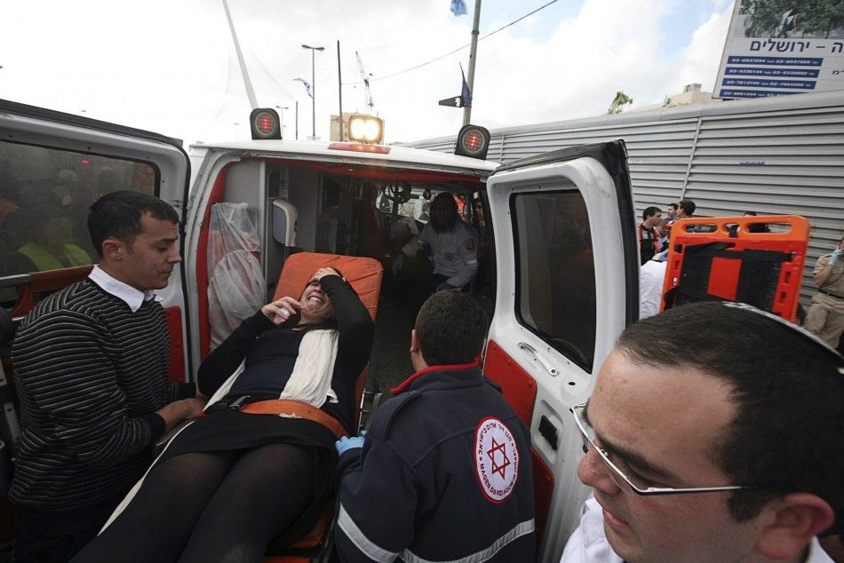 Israeli medics evacuate a woman at the scene of an explosion in Jerusalem