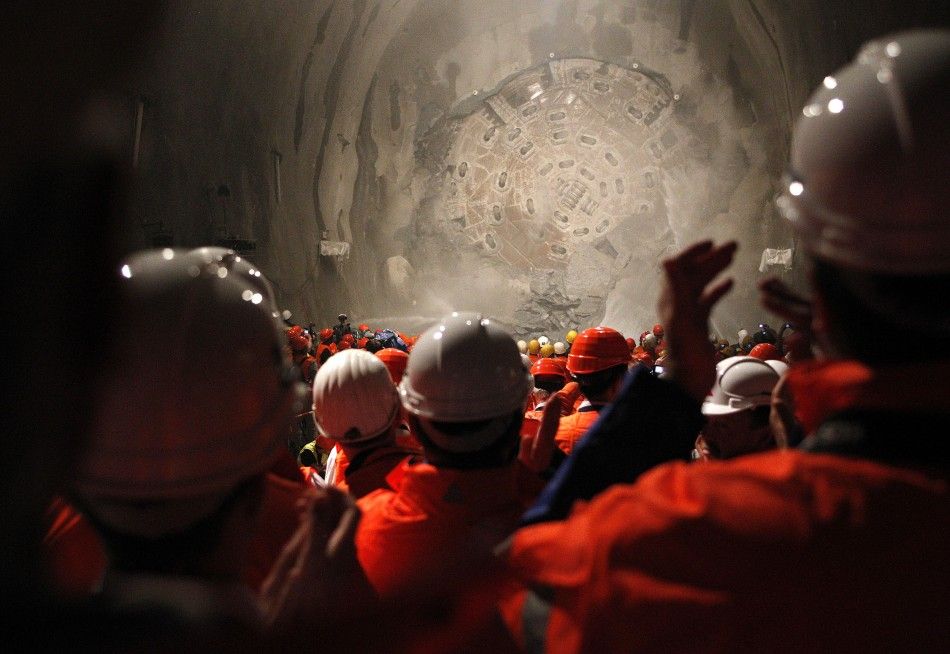 Miners watch as the drill machine quotSissiquot breaks through the rock at the final section Faido-Sedrun construction site of the NEAT Gotthard Base Tunnel 