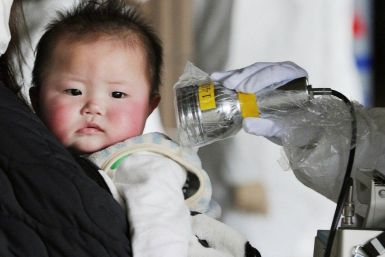 A baby undergoes a check for radiation in Fukushima City, northeastern Japan