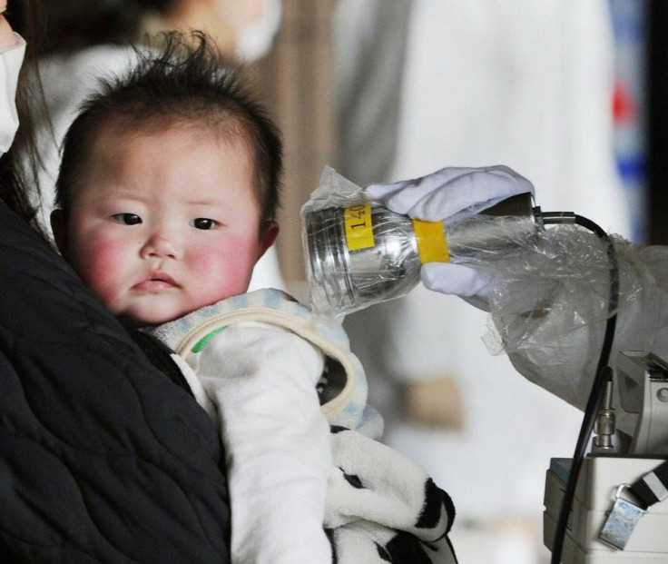 A baby undergoes a check for radiation in Fukushima City, northeastern Japan