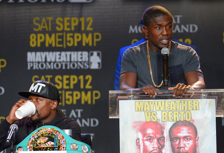  Andre Berto speaks to the media as Floyd Mayweather, Jr. listens 