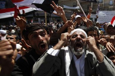 Anti-government protesters shout slogans during a rally to demand the ouster of Yemen's President Ali Abdullah Saleh outside Sanaa University