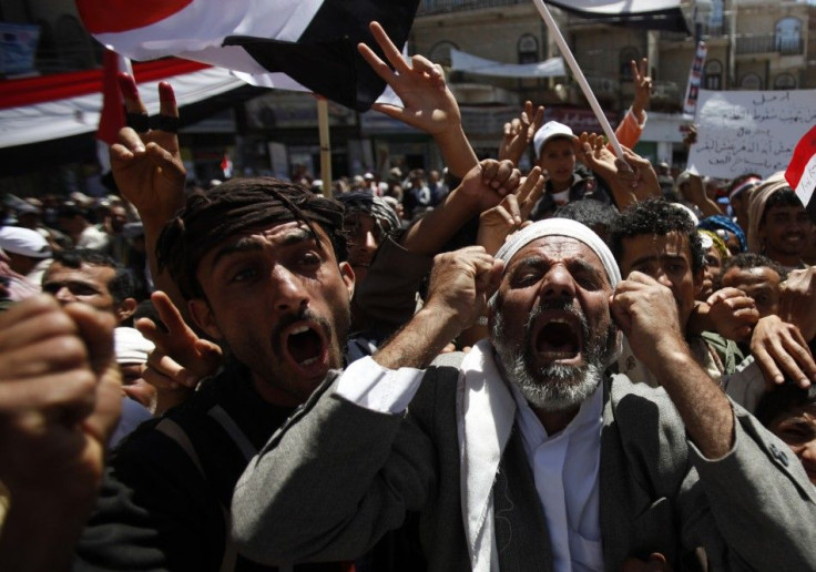 Anti-government protesters shout slogans during a rally to demand the ouster of Yemen's President Ali Abdullah Saleh outside Sanaa University