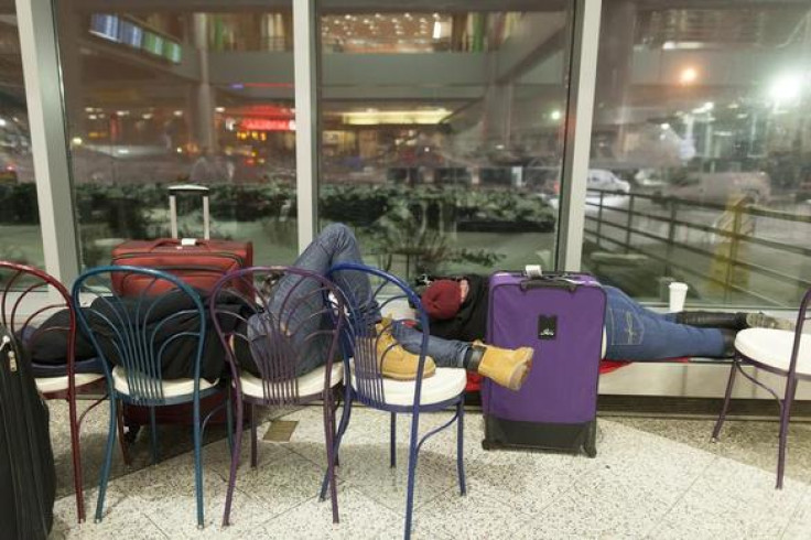 People wait for their delayed flights at LaGuardia Airport in New York, January 3, 2014. REUTERS-Zoran Milich