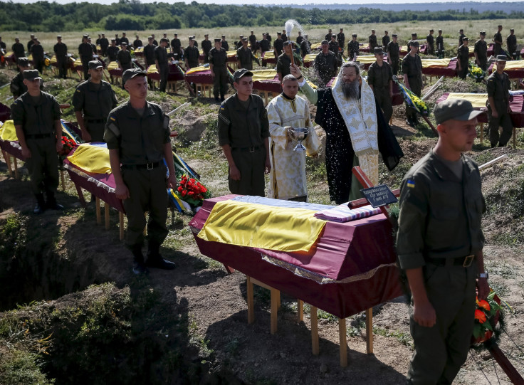 Unidentified soldiers are buried in Ukraine. 