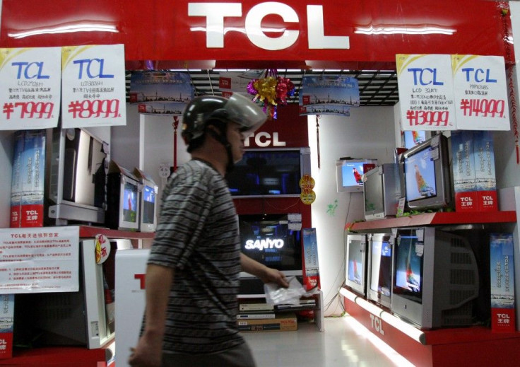 Chinese man walks past TCL television store in Shanghai.