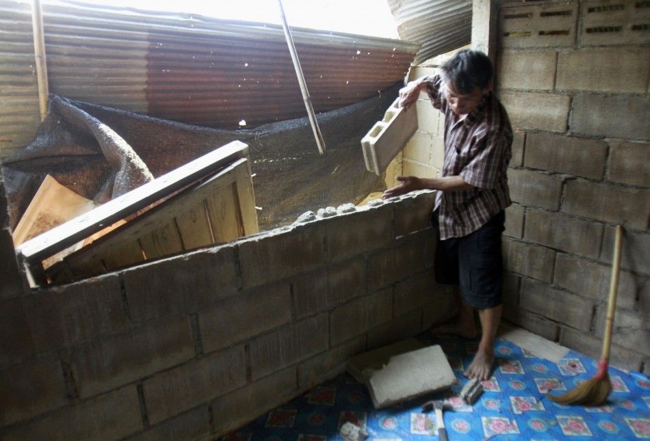 A villager clears his house after an earthquake in Chiang Rai province 