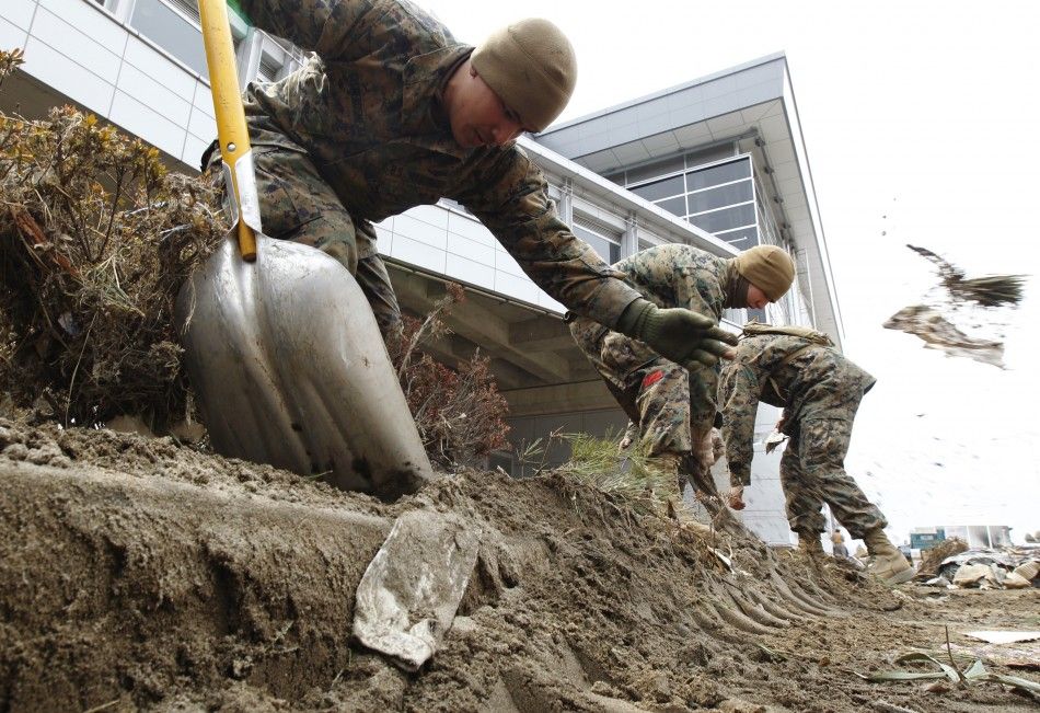 U.S. marines based in Japan start to clear rubble after the earthquake and tsunami in Sendai, Miyagi Prefecture