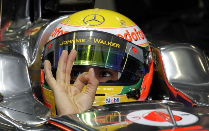 McLaren F1's Hamilton gestures from his car during the the first practice session of the Australian F1 Grand Prix in Melbourne.