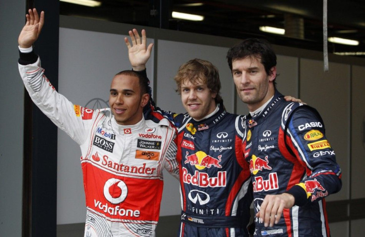 Red Bull driver Vettel of Germany, teammate Webber of Australia and McLaren's Hamilton of Britain pose for photographers after the qualifying session of the Australian F1 Grand Prix in Melbourne.