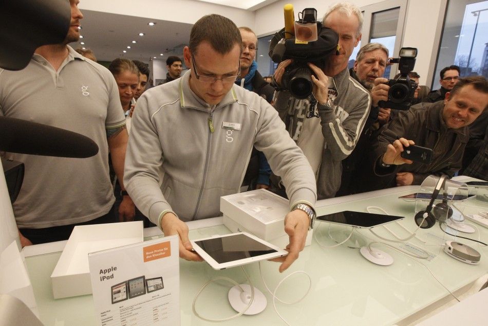 People queue up at a computer store to buy a new iPad 2 in Berlin