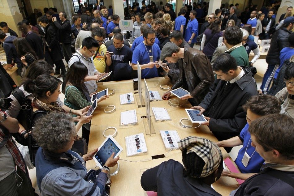 Customers discover the Apples iPad 2 in a Paris Apple store after its official launch for direct purchase in France 
