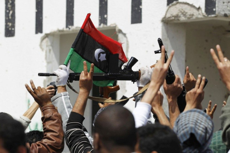 Rebels celebrate after forces loyal to Muammar Gaddafi fled following coalition air strikes around the eastern town of Ajdabiya