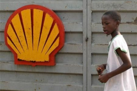 A file photo shows a Nigerian boy walking past the logo of Dutch oil giant Shell near Warri in the volatile Niger-Delta
