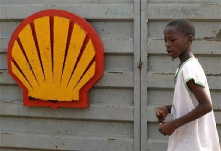 A file photo shows a Nigerian boy walking past the logo of Dutch oil giant Shell near Warri in the volatile Niger-Delta