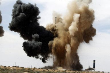 Smoke rises during an air strike at a rebel fighters checkpoint in Al Ugaila.