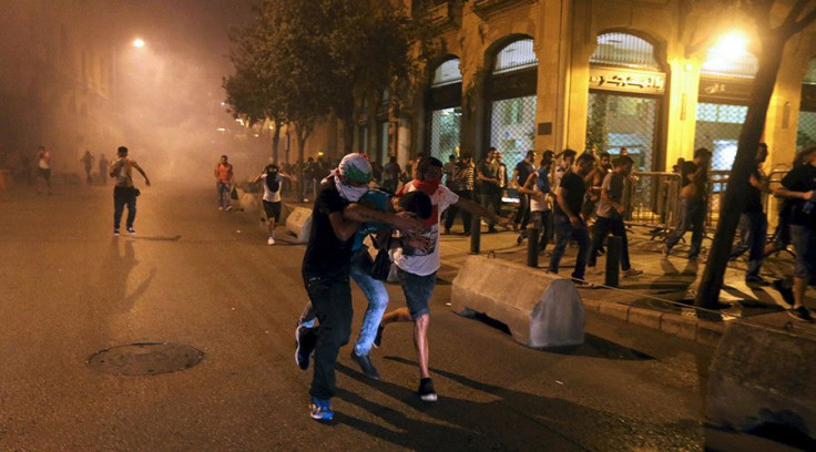 Protestors flee during clashes with police in Beirut. 