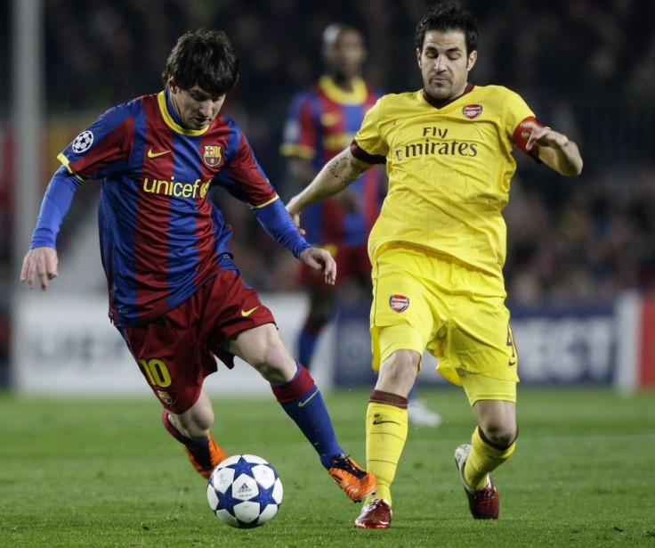 Barcelona's Messi controls the ball challenged by Arsenal's Fabregas during their Champions League soccer match in Barcelona.