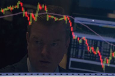 A trader looks on as stocks recover. 