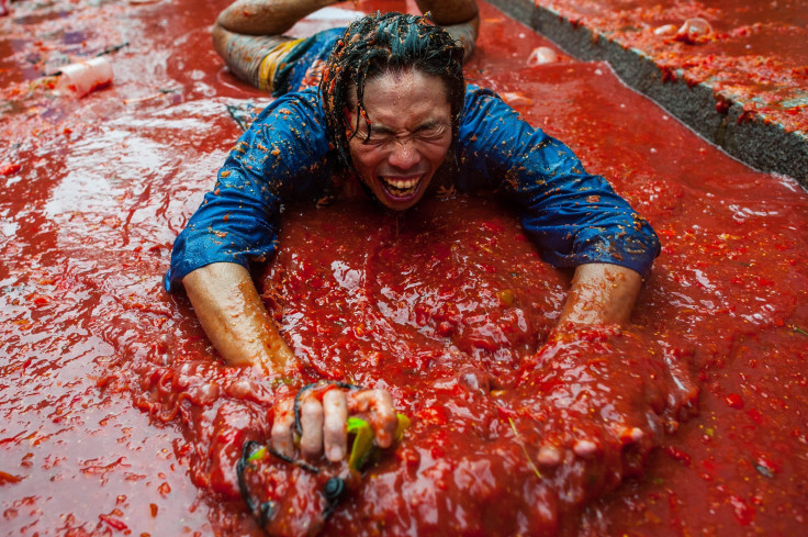 A man slides in tomato sauce at La Tomatina