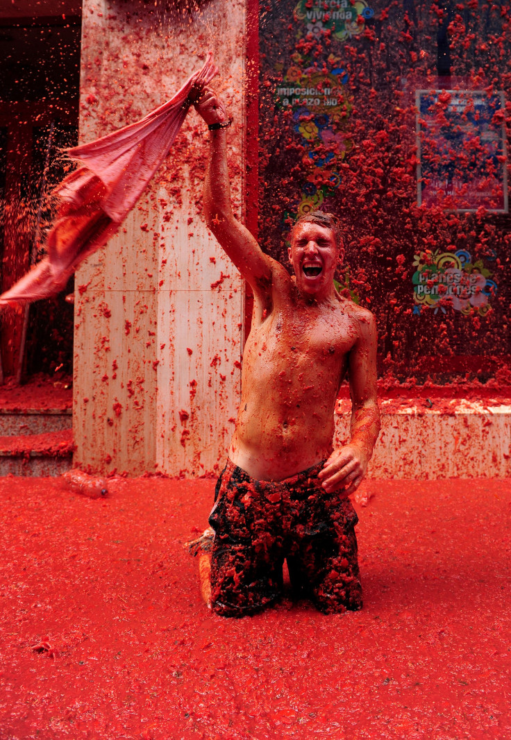 A man swings clothing around his head at La Tomatina