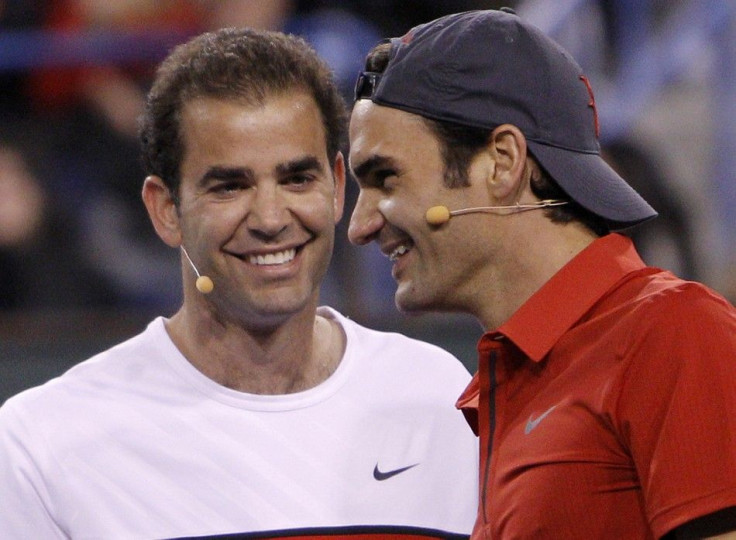 Federer and Sampras smile as they play against Agassi and Nadal during their doubles exhibition doubles in the Hit for Haiti fund raiser event at the Indian Wells.