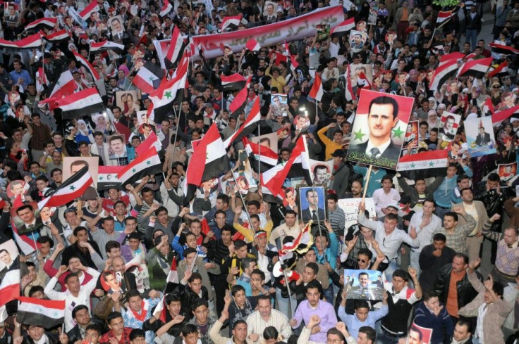 Supporters of Syria's President Bashar al-Assad shout slogans in Syria's northern city of Aleppo March 27, 2011.
