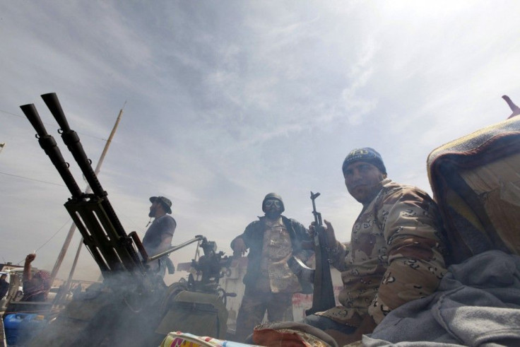 Rebels celebrate after recapturing the town of Ras Lanuf, March 27, 2011.