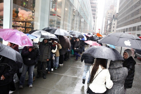 Customers stand in line outside Apple's flagship 5th Avenue store to purchase iPad 2 tablets in New York
