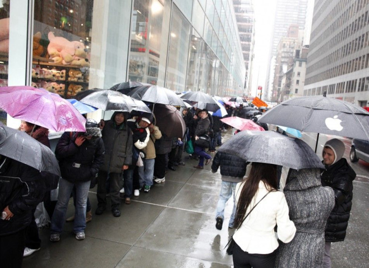 Customers stand in line outside Apple's flagship 5th Avenue store to purchase iPad 2 tablets in New York