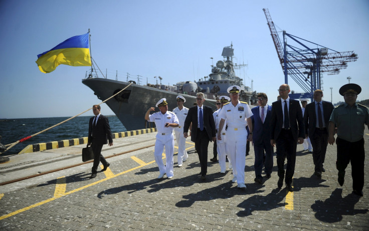 A U.S. admiral walks past a Ukrainian ship