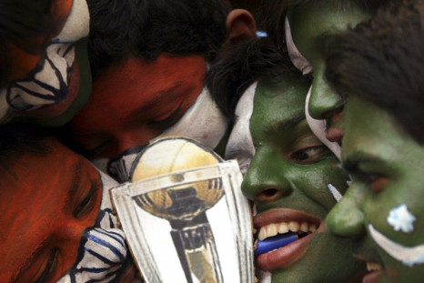 Cricket fans with their faces painted with the Indian and Pakistani national flags pose in Hyderabad.