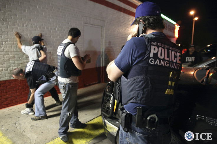 Immigration officials detain a suspect during a raid