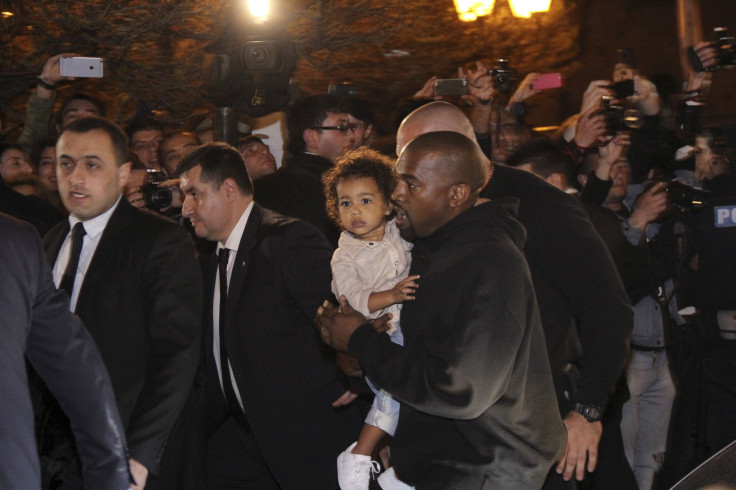 [08:31] Rapper Kanye West carries his daughter North
