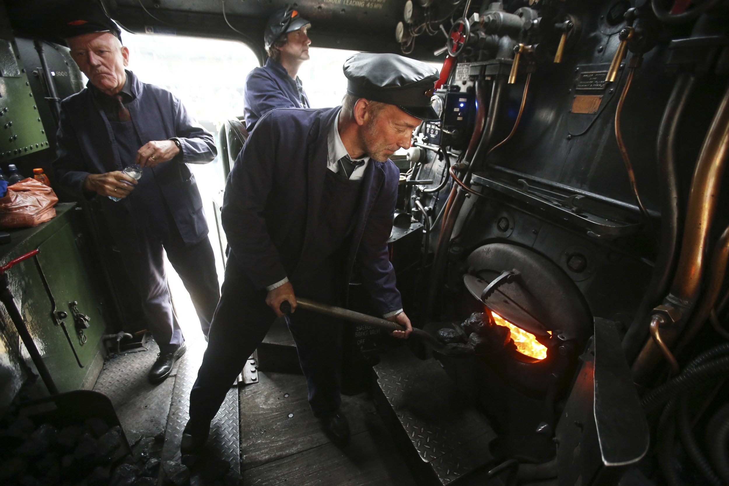 1228  L-R Jim Smith, Steve Hanczar and Tony Jones work in the engine of a steam train at Edinburghs Waverley Station