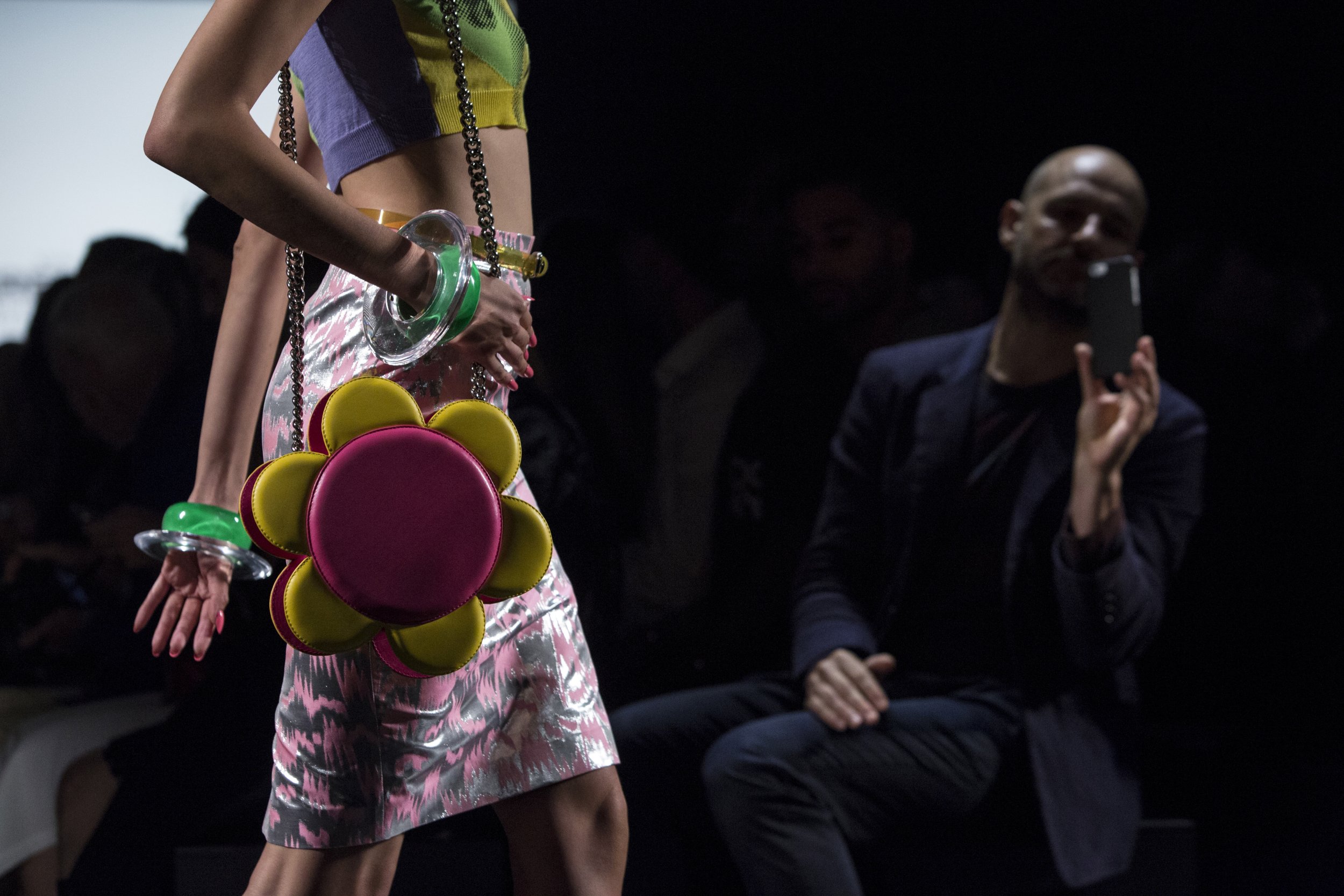 1205 An audience member looks on as a model presents a creation from the Jeremy Scott SpringSummer 2016 collection
