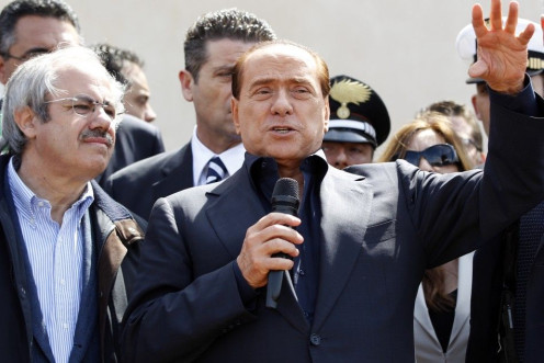 Italian PM Berlusconi speaks after arriving at at the southern Italian island of Lampedusa