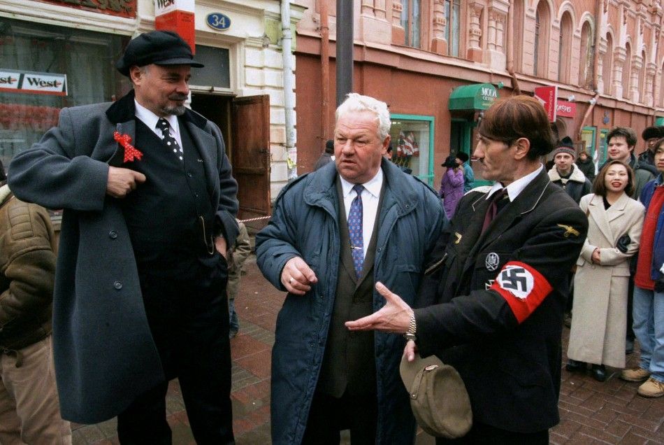 Look alikes of Vladimir Lenin L, Boris Yeltsin C and Adolf Hitler gather on Arbat street in Mosc..