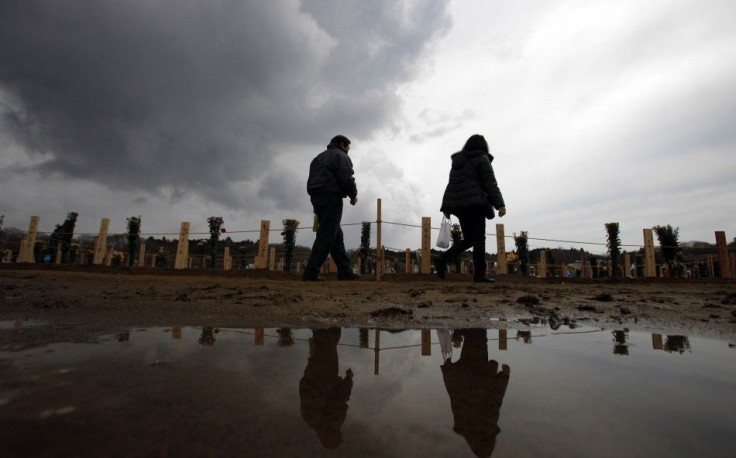People visit a temporary mass gravesite for victims of the March 11 earthquake and tsunami in Higashi-Matsushima in Miyagi prefecture, northern Japan