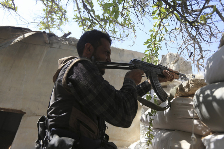 A Free Syrian Army fighter fires a rifle