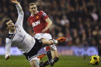 Fletcher of Manchester United tackles Bale of Tottenham Hotspur during their English Premier League soccer match in London.