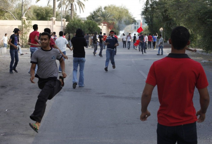 Anti-government protesters flee after riot police fire rounds of tear gas to disperse them in the mainly Shi'ite village of Diraz