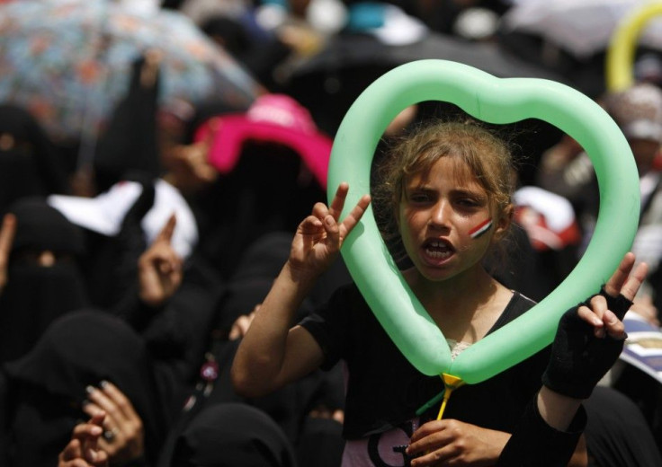 A girl holds a balloon while shouting slogans during a demonstration to demand the ouster of Yemen's President Ali Abdullah Saleh outside of Sanaa University