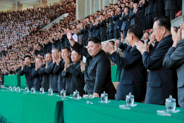 kim Jong Un waves at fans inside the country's national stadium