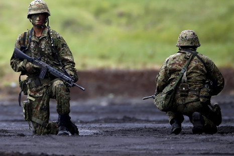 Japanese soldiers kneel during a training exercise