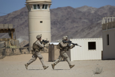 Two U.S. Army soldiers run for cover during a live training exercise